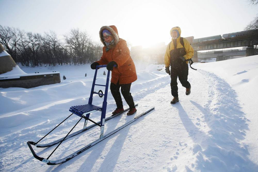 Viola and Dan Prowse, local kicksledding enthusiasts, take their Esla T7 sled for a spin. (John Woods / Winnipeg Free Press)