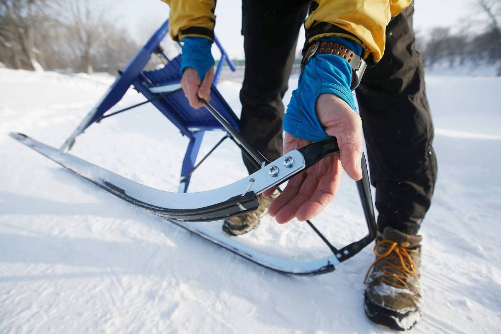 Viola and Dan Prowse use their Esla T7 kicksled to explore the city from the vantage point of the river. (John Woods / Winnipeg Free Press)