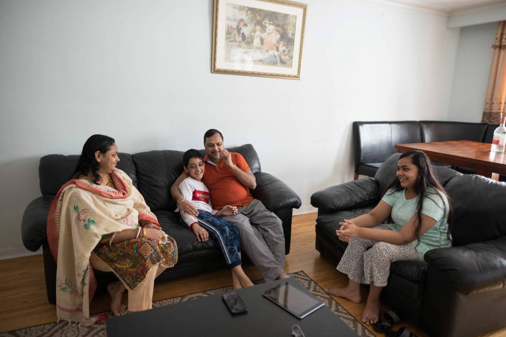 Sreeti Rani Barman, Sattik, 11, Subir Barman and Saptorshi, 14, at their home in Mississauga, Ont. (Tijana Martin / Winnipeg Free Press)