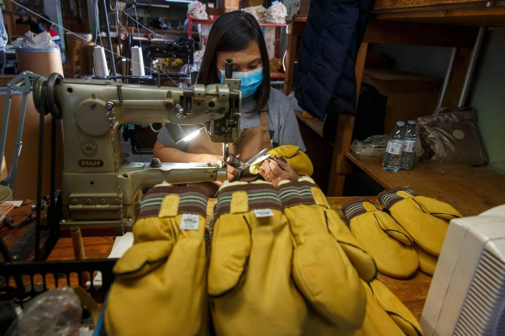 MIKE DEAL / WINNIPEG FREE PRESS
Rosalinda Gabisan sews the liner into the garbage mitts