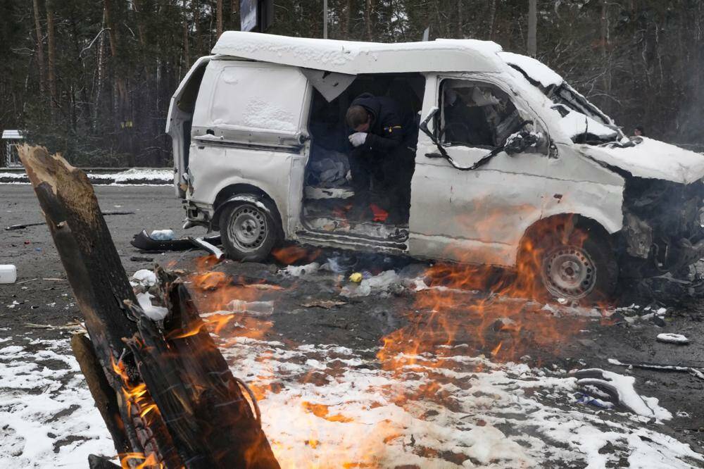 A man reacts inside a vehicle damaged by shelling, in Brovary, outside Kyiv, Ukraine, Tuesday, March 1, 2022. Russian shelling pounded civilian targets in Ukraine’s second-largest city again Tuesday and a 40-mile convoy of tanks and other vehicles threatened the capital — tactics Ukraine’s embattled president said were designed to force him into concessions in Europe’s largest ground war in generations. (AP Photo/Efrem Lukatsky)