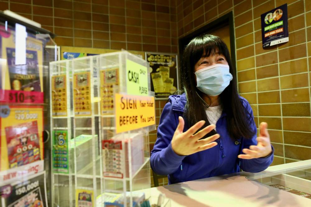 Lotto Spot! kiosk owner Julia Ryu says she has about 30 per cent of the customers she did before the pandemic. (Ruth Bonneville / Winnipeg Free Press)