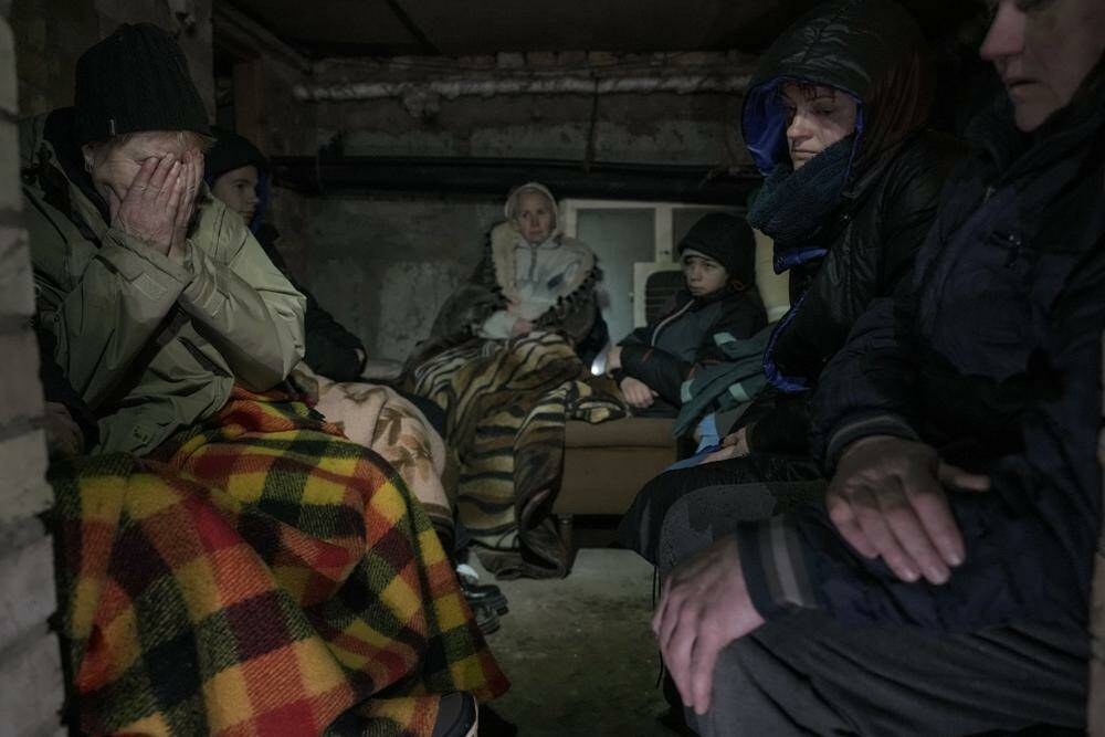 A woman cries in the small basement of a house crowded with people seeking shelter from Russian airstrikes, outside the capital Kyiv, Ukraine, Wednesday, March 2, 2022. Russia renewed its assault on Ukraine’s second-largest city in a pounding that lit up the skyline with balls of fire over populated areas, even as both sides said they were ready to resume talks aimed at stopping the new devastating war in Europe. (Vadim Ghirda / The Associated Press)