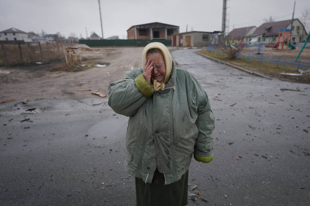 A woman cries outside houses damaged by a Russian airstrike, according to locals, in Gorenka, outside the capital Kyiv, Ukraine, Wednesday, March 2, 2022. Russia renewed its assault on Ukraine’s second-largest city in a pounding that lit up the skyline with balls of fire over populated areas, even as both sides said they were ready to resume talks aimed at stopping the new devastating war in Europe. (AP Photo/Vadim Ghirda)