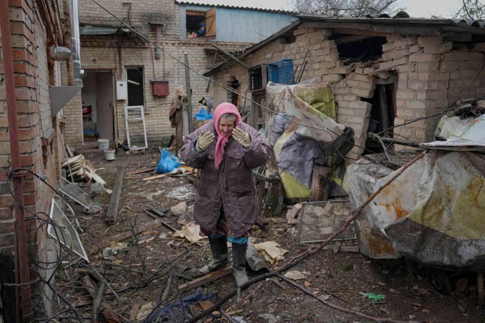 A woman is overwhelmed by emotion in the backyard of a house damaged by a Russian airstrike, according to locals, in Gorenka, outside the capital Kyiv, Ukraine, Wednesday, March 2, 2022. Russia renewed its assault on Ukraine’s second-largest city in a pounding that lit up the skyline with balls of fire over populated areas, even as both sides said they were ready to resume talks aimed at stopping the new devastating war in Europe.(AP Photo/Vadim Ghirda)