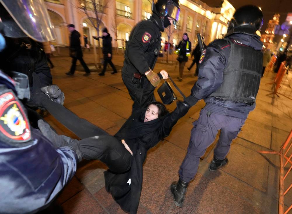 Police detain a demonstrator during an action against Russia’s attack on Ukraine in St. Petersburg, Russia, Wednesday, March 2, 2022. Protests against the Russian invasion of Ukraine resumed on Wednesday, with people taking to the streets of Moscow and St. Petersburg and other Russian towns despite mass arrests. (AP Photo/Dmitri Lovetsky)