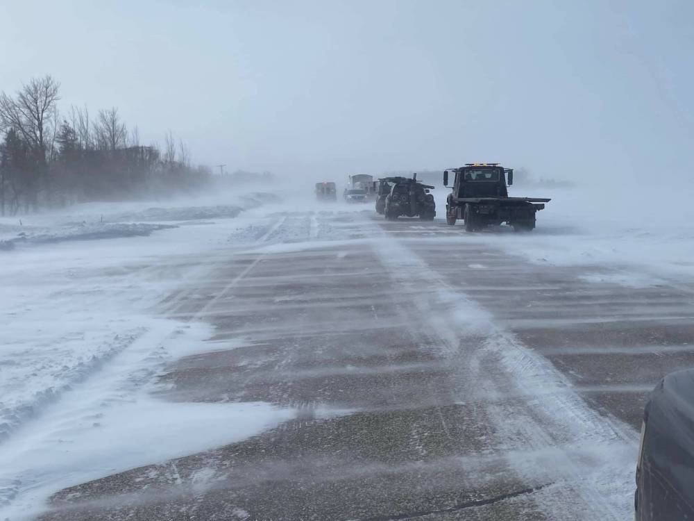 Tow trucks and other vehicles at the scene of the crash on McGillivray Boulevard, about a kilometre from the Perimeter Highway. (Kon Paseschnikoff photo)