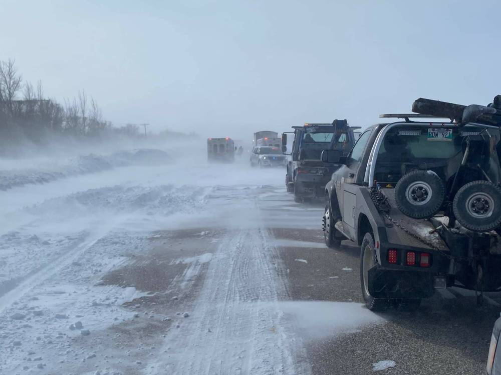 Tow trucks and other vehicles at the scene of the crash on McGillivray Boulevard, about a kilometre from the Perimeter Highway. (Kon Paseschnikoff photo)