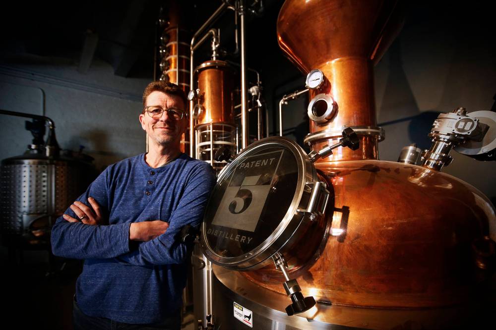 JOHN WOODS / WINNIPEG FREE PRESS
Brock Coutts, co-owner of Patent 5 Distillery, with his still in Winnipeg. Much of the interior decor has been repurposed from the old St Regis Hotel and will be opening soon.