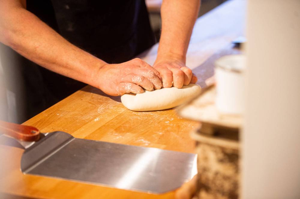 Mike Sudoma / Winnipeg Free Press
Ozuk gets his hands dirty kneading a batch of dough in his kitchen.