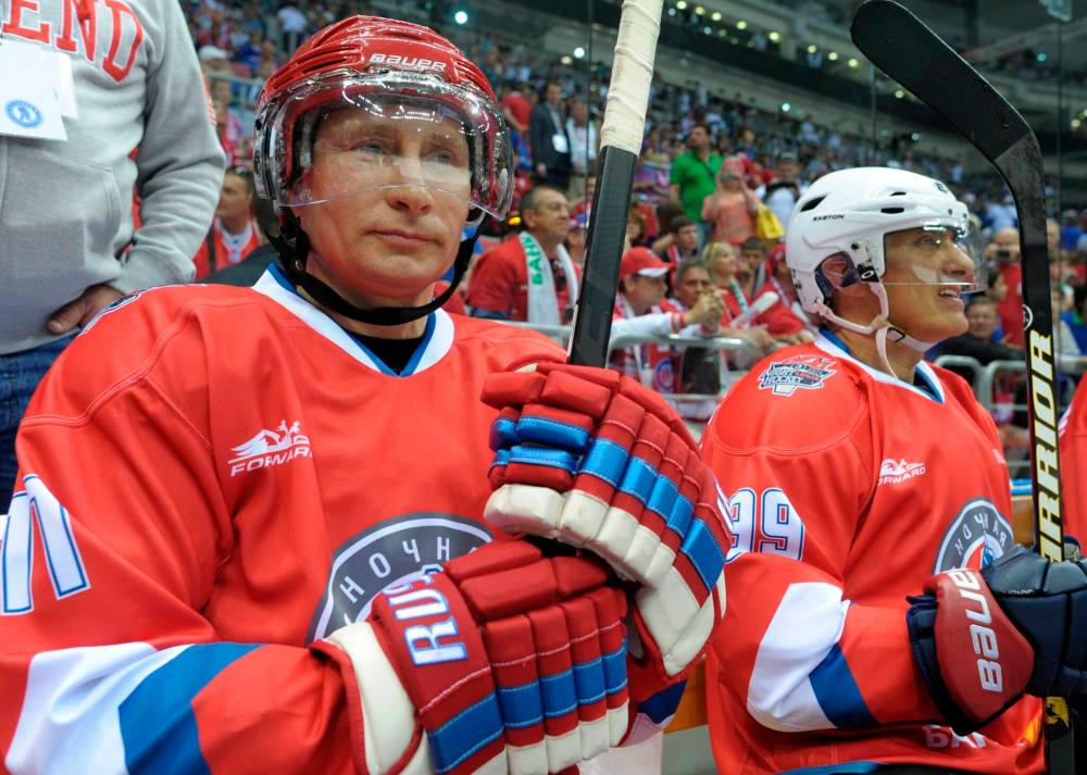 Alexei Druzhinin / The Associated Press files
In this 2014 photo, Russian President Vladimir Putin takes part in a hockey game between Russian amateur players and stars in Sochi’s Bolshoy Arena. Players are advised to ‘part like the Red Sea’, allowing Putin to score at will despite sub-par hockey skills.