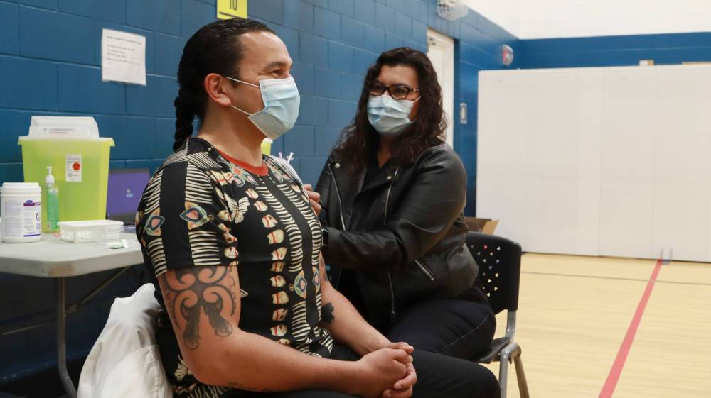 SUPPLIED
Anderson gives NDP Leader Wab Kinew a COVID-19 vaccination last year.
