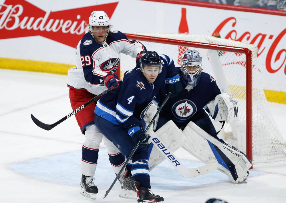 JOHN WOODS / THE CANADIAN PRESS FILES
Defenceman Neal Pionk (centre) was blunt in his assessment of the Jets season. ‘We had a really good roster and totally underachieved,’ he said.