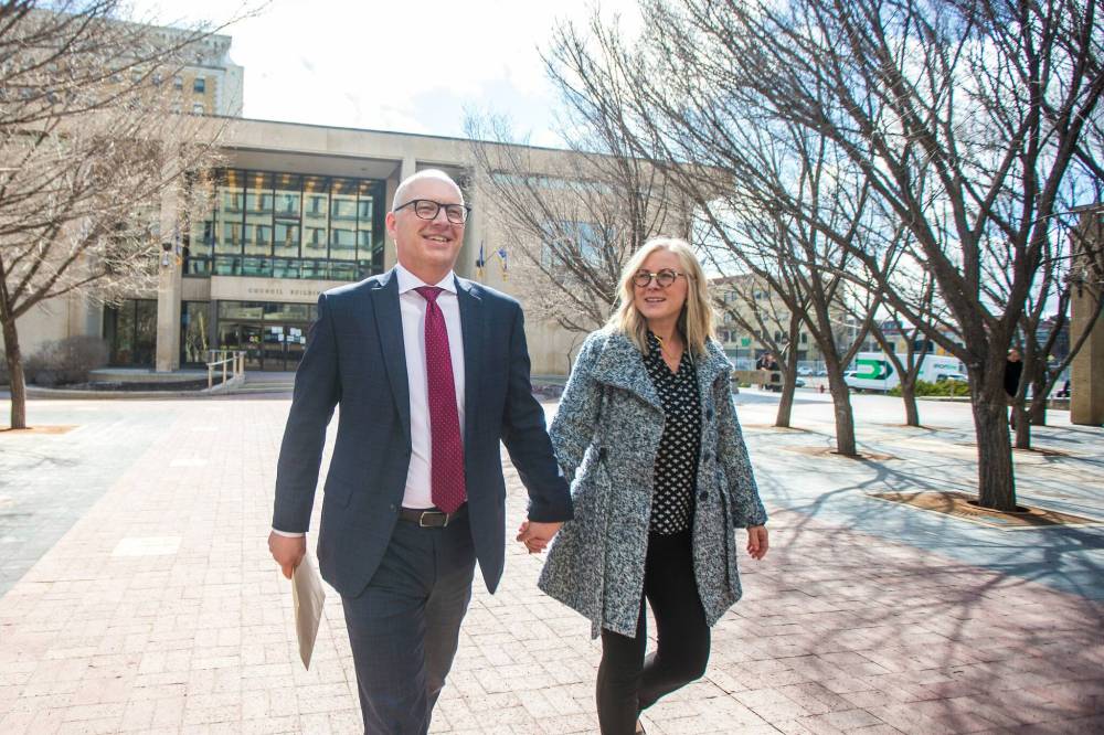 MIKAELA MACKENZIE / WINNIPEG FREE PRESS
Scott Gillingham walks to the clerk’s office with his wife, Marla, to register for the mayoral race at City Hall in Winnipeg on Monday.