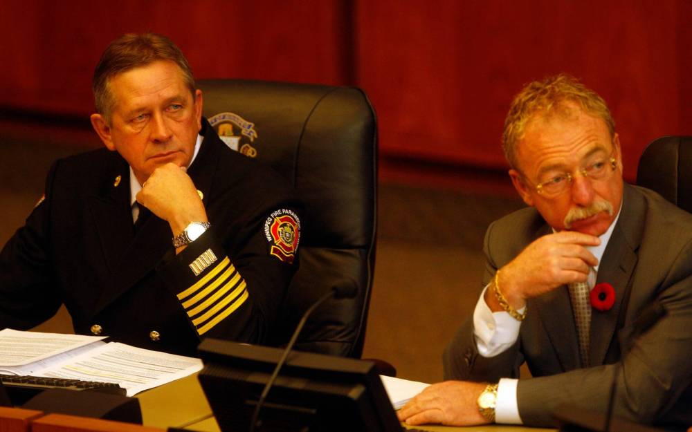 Former fire chief Reid Douglas (left) and former CAO Phil Sheegl attend a meeting in 2012 to address how an extra $2.2 million was added to the construction cost of Fire Hall No. 11 on Portage Avenue at the Route 90 intersection. (Ken Gigliotti / Winnipeg Free Press files)