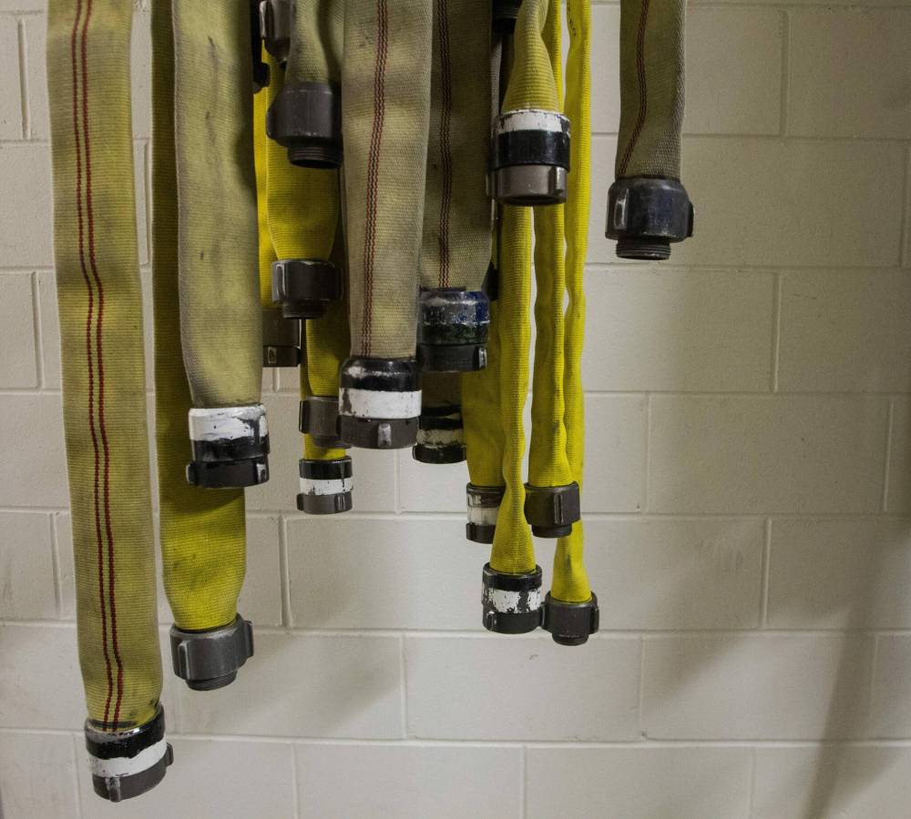 Fire hoses dry out at Station No. 11 in 2014. (Mike Deal / Winnipeg Free Press files)