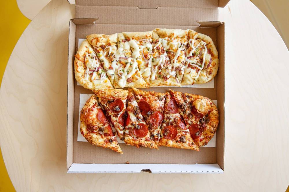 MIKE DEAL / WINNIPEG FREE PRESS
The Oh! Canadian pizza and the Potato Pops pizza (top), which has olive oil, sea salt, mashed yukon potatoes, mozzarella, cheddar, bacon, red onions, rosemary, green onions, and truffle aioli drizzle.