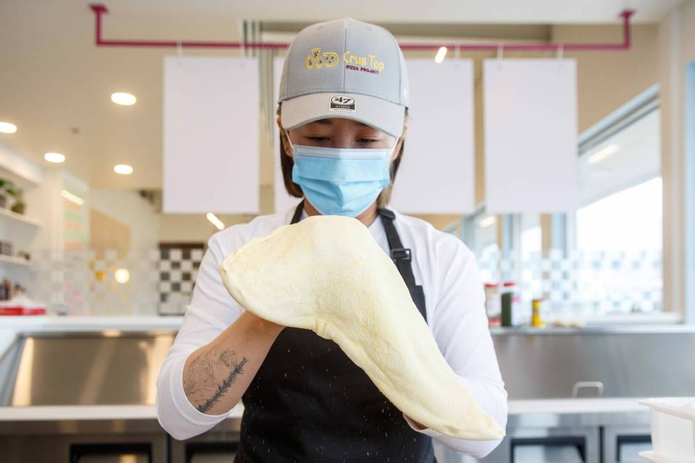 MIKE DEAL / WINNIPEG FREE PRESS
Xu works with some dough at CrusTop, her bright new Corydon Avenue pizza joint.