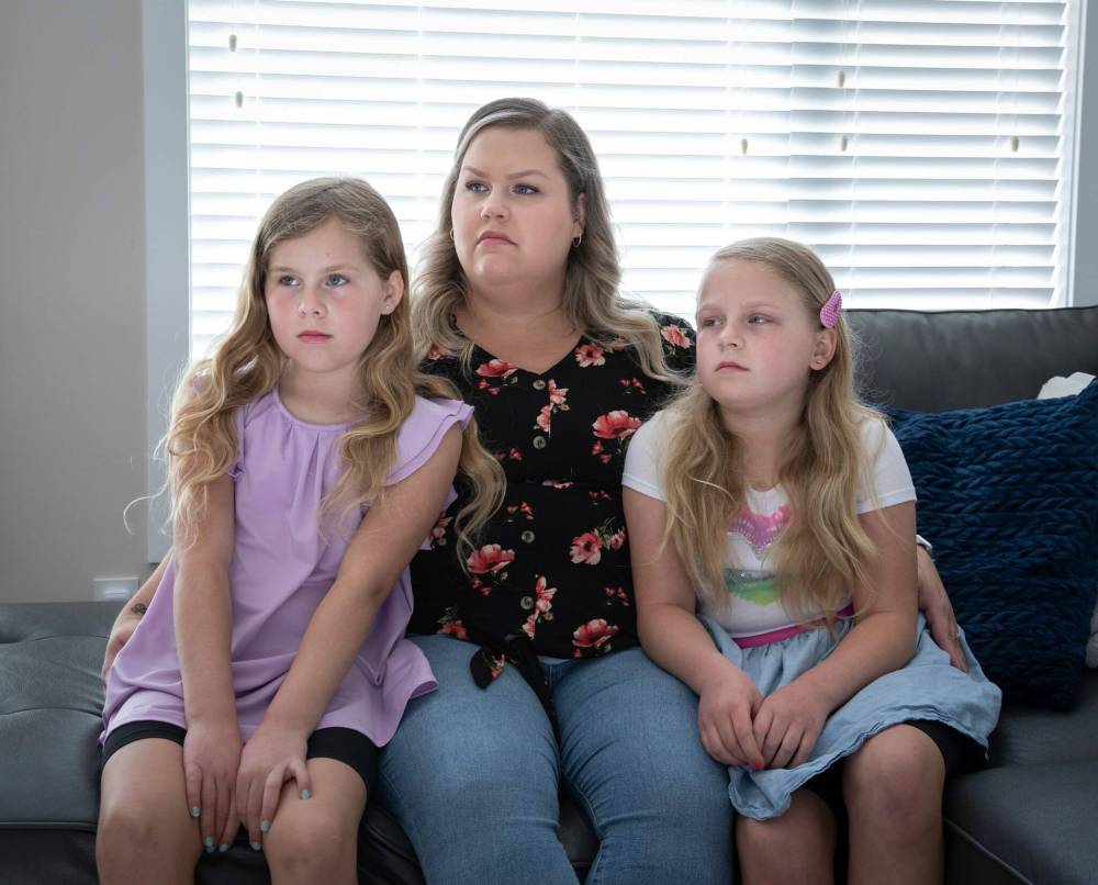 Samantha Kuzyk poses with her daughters Peyton (left) and Aubrey. She has contacted police about bullying at the school her daughters attend. (Jessica Lee / Winnipeg Free Press)