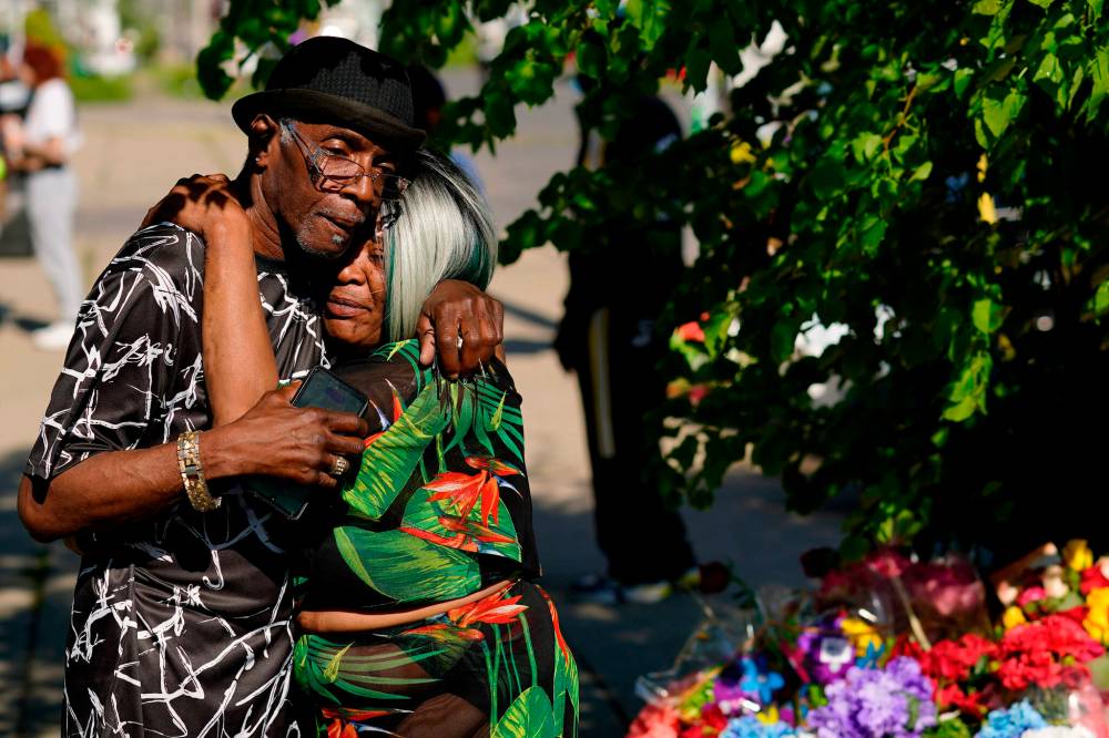MATT ROURKE / THE ASSOCIATED PRESS FILES
People embrace outside the scene of the mass shooting at a supermarket in Buffalo, N.Y. on Saturday. The shooting is the latest example of targeted racial violence in the United States.