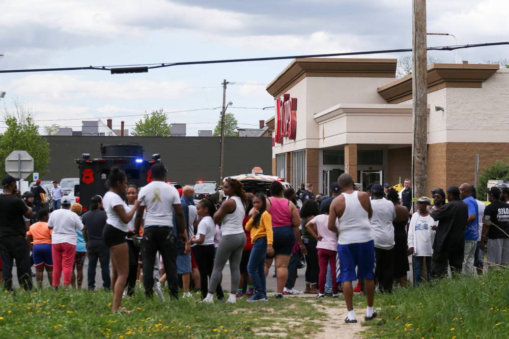 JOSHUA BESSEX / THE ASSOCIATED PRESS FILES
A crowd gathers as police investigate after the May 14 mass killing at a supermarket in Buffalo, N.Y.