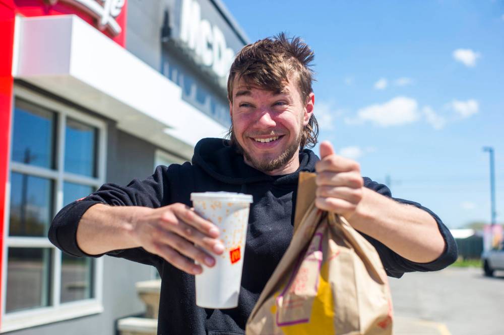 MIKAELA MACKENZIE / WINNIPEG FREE PRESS
‘Everything’s going up,' says Harley Henschell, shown here leaving McDonald’s on Pembina Highway with his fast food order. ‘It is what it is. (You just) have to budget more.’