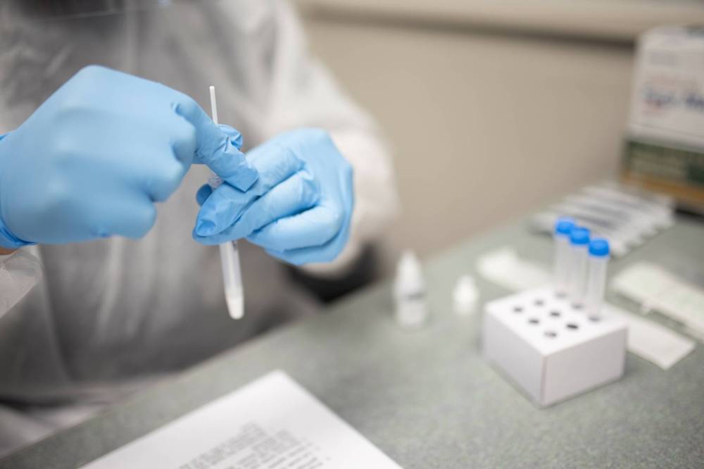 Jhorman Henao processes a COVID-19 rapid test at Rimot.io Inc. in Dartmouth, N.S., Tuesday, June 22, 2021. As workers return to office buildings and job sites across the country, some are being offered rapid COVID-19 tests at work. THE CANADIAN PRESS FILES/Riley Smith