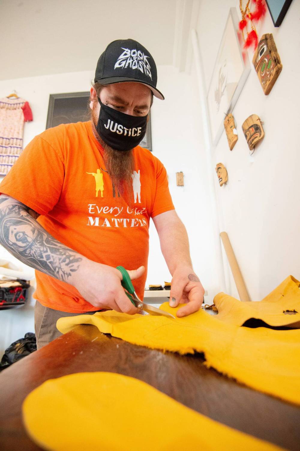 Mike Sudoma / Winnipeg Free Press Keith Proulx, Owner of Cree Ations and Artist Showcase, cuts out a pattern for moccasins in his shop/workshop on Main St Monday afternoon December 13, 2021