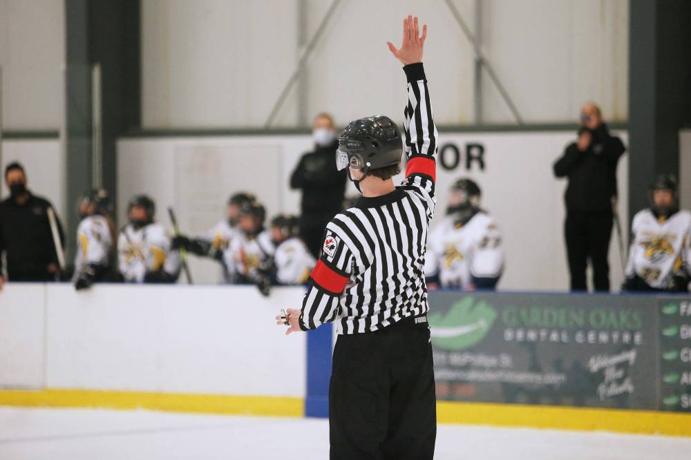 JOHN WOODS / WINNIPEG FREE PRESS Luke Janus, 17, a referee for 5 years, works a game between the Predators and Titans at Seven Oaks Arena Monday, January 10, 2022. Reportedly it is becoming harder to book hockey referees because many of them are quitting the job due to unreasonable abuse and low wages. Re: McIntyre