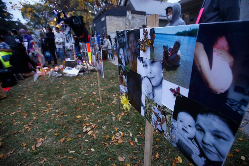 Pictures of Jennifer Dethmers and her son Anthony appear on signs at a vigil in September 2020. (John Woods / Winnipeg Free Press files)