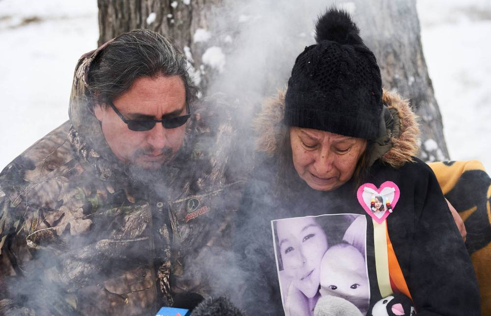 Candy Volk, grandmother of 10-month-old Anthony Dethmers and his mother Jennifer Dethmers, is comforted by her cousin Colin James at a press conference in Winnipeg in October 2020. (David Lipnowski / The Canadian Press files)