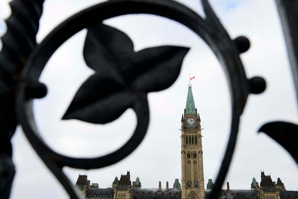 THE CANADIAN PRESS/Sean Kilpatrick
The Parliament Hill Peace Tower flag flies at half-mast in Ottawa on Wednesday.
