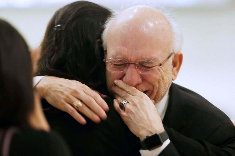 JOHN WOODS / WINNIPEG FREE PRESS
Kourosh Doustshenas, partner of Forough Khadem, is comforted as he weeps at the memorial.