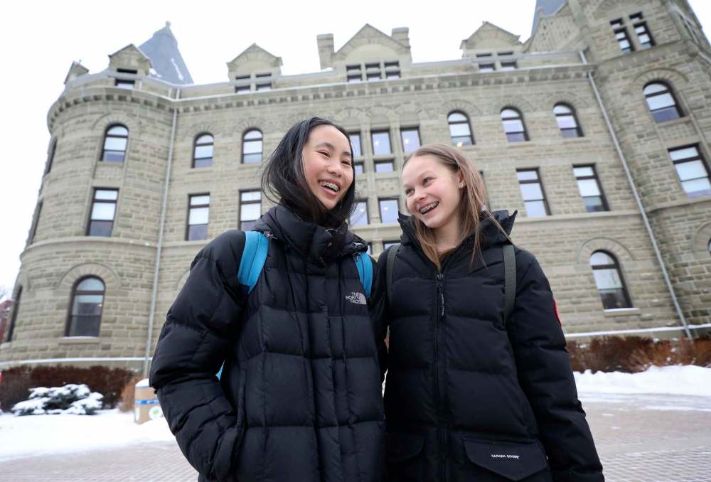 Elisa Woo, left, and Taisi Tollasepp at the University of Winnipeg Collegiate, where Grade 9 to 12 students complete the academic portion of their day.