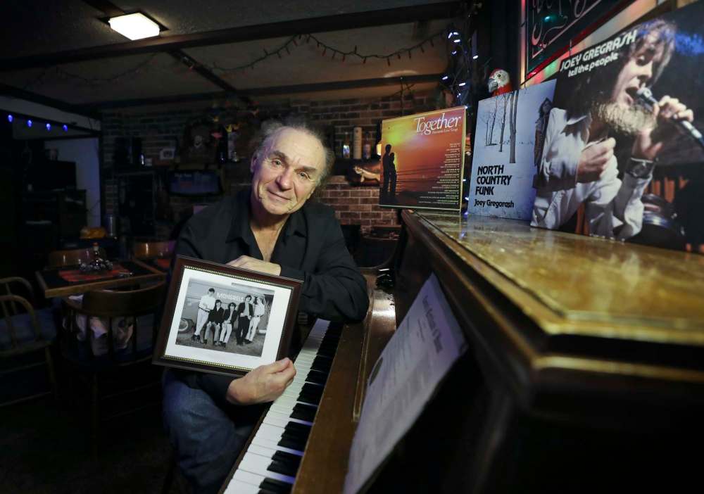 Gregorash with a picture of the Mongrels, his first band from the ’60s. (Ruth Bonneville / Winnipeg Free Press)