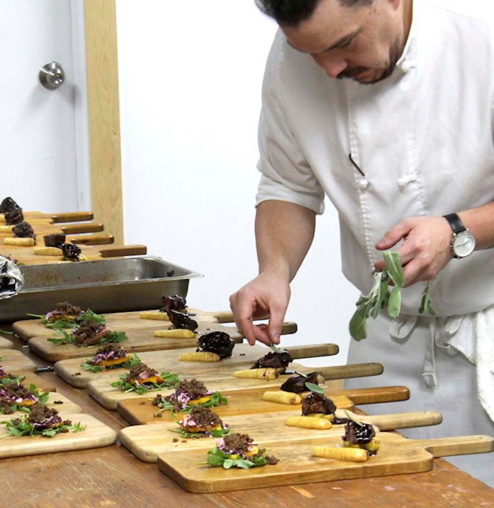 Chef Steven Watson prepares pre-colonial food during Ishkode last fall, using ingredients found in Manitoba prior to the arrival of the white settlers. (Ishkode Indigenous Cuisine Pop Up / Facebook)