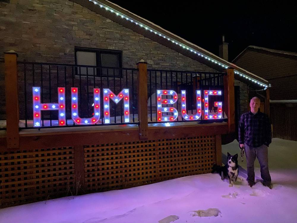 SUPPLIED
Sid Farmer’s grandson, Mike Halprin, with his tribute to his grandfather’s famous Winnipeg Humbug sign at his own home in Canmore, Alta.