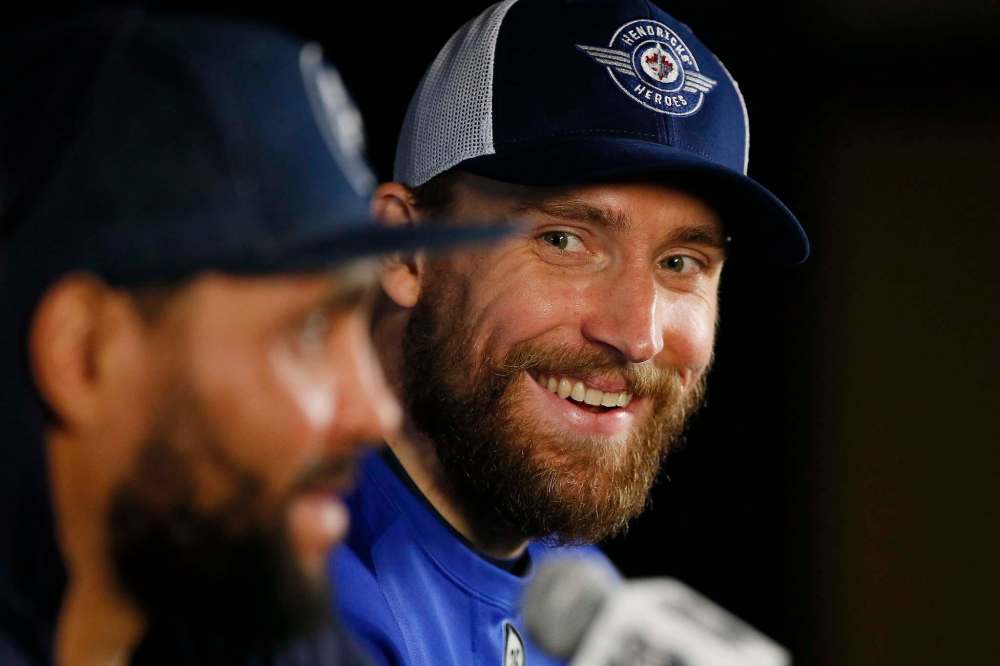In happier times: Blake Wheeler (right) jokes about having to play defence for Dustin Byfuglien following their first game against the Vegas Golden Knights in the NHL Western Conference Final. (John Woods / The Canadian Press files)
