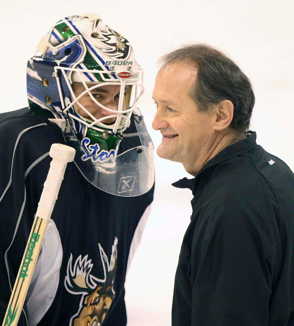 Manitoba Moose goaltender Eddie Lack, left, shares a laugh with coach Rick St. Croix during a break in practice in 2011. (Joe Bryksa / Free Press files)