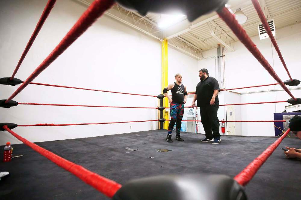 Pro wrestler AJ Sanchez (The Canadian Crusher), right, and George Hudson, who wrestles under the name Dash Royal. (John Woods / Winnipeg Free Press)