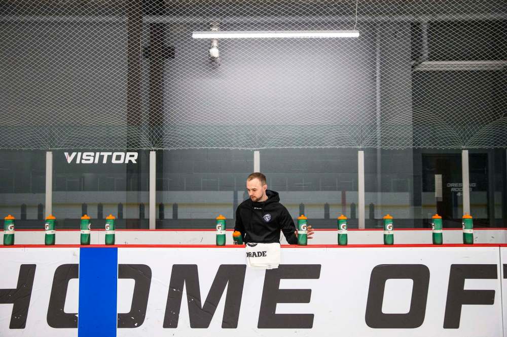 Darris Hardern, team athletic therapist, preps water bottles and towels for the Winnipeg Ice practice on Feb. 8.