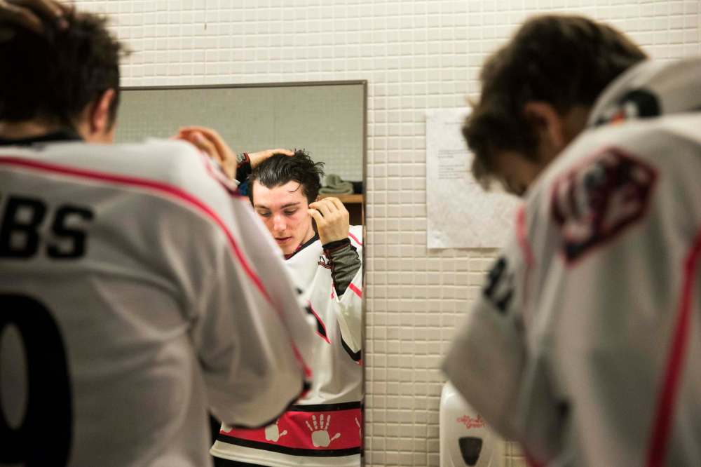 Team captain Peyton Krebs slicks his hair back minutes before the warm-up skate at the Wayne Fleming Arena.