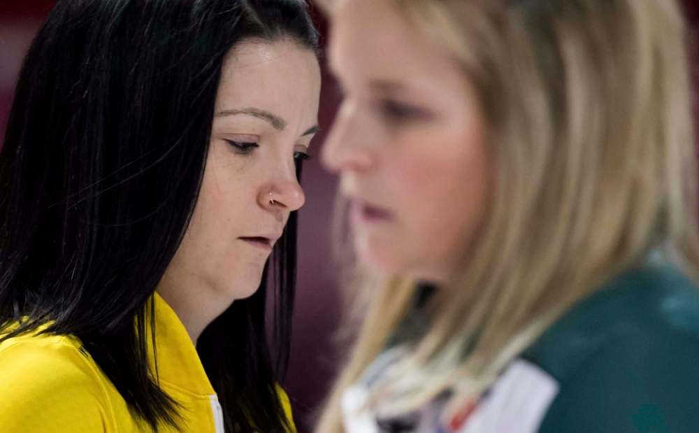 Team Manitoba skip Kerri Einarson bosses her sweepers during the 1-vs.-2 Page playoff at the Scotties Tournament of Hearts Saturday in Moose Jaw. (Jonathan Hayward / The Canadian Press)