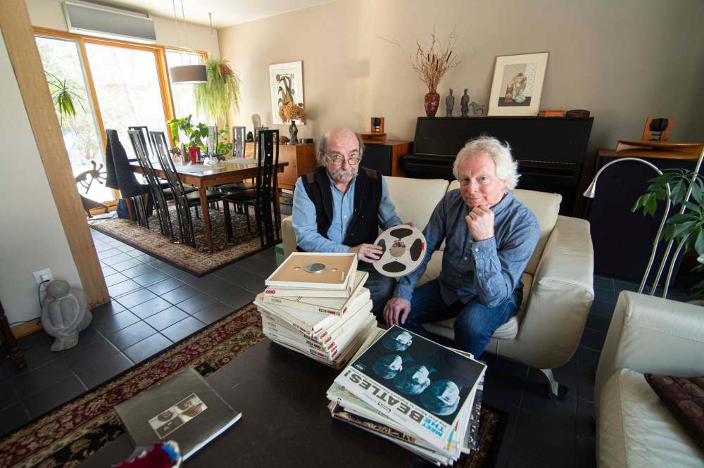 Michael Gillespie (left) and Dan Donahue (right) with Gillespie’s collection of Beatles vinyl and reels from the radio program, The Story of the Beatles, which originally aired on Toronto radio station CHUM in 1970.
