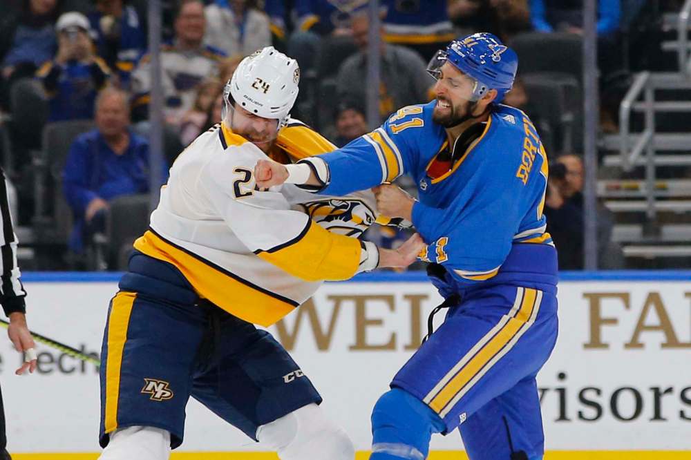 St. Louis Blues' Robert Bortuzzo (right) gets a shot in against Nashville's Jarred Tinordi on Saturday. (Billy Hurst / The Associated Press files)