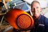 Electrical Contractor Chuck Lewis with a light similar to what he's installed at some reduced speed school zones. (Phil Hossack / Free Press files)