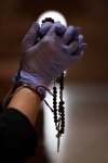 Bernat Armangue / The Associated Press Files
A Catholic worshipper wearing protective gloves prays the rosary at the Santa Maria de Cana parish in Pozuelo de Alarcon, near Madrid, Spain, on March 15.