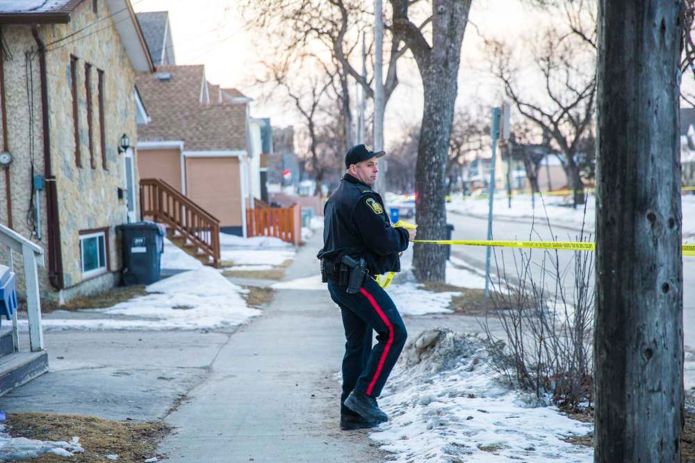 Police block off Burrows Street as they investigate the city's eighth homicide of the year. (Mikaela MacKenzie / Winnipeg Free Press)