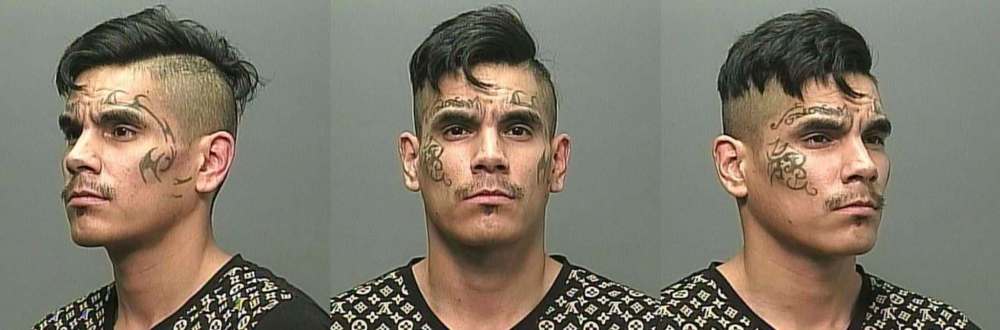 A Canada-wide arrest warrant has been issued for Christian James Bruce, 28, described as 5-foot-9, 146 pounds, with brown eyes and black hair, and various skull-related tattoos on both arms, as well as tribal-style tattoos on his face. (Supplied)