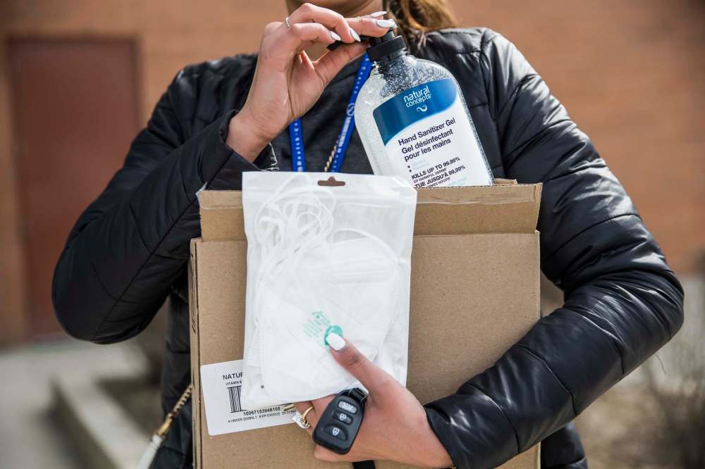 Saranjit Dhaliwal, Misercordia staff, shows the hand sanitizer and N95 masks she bought at Showcase at Polo Park mall in Winnipeg on April 1, 2020. (Mikaela MacKenzie / Winnipeg Free Press)